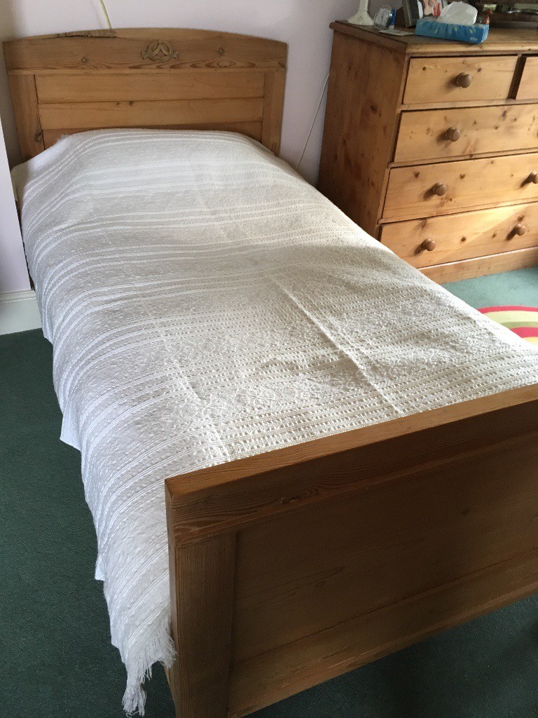 Two enchanting antique pine single beds with carved decoration on the