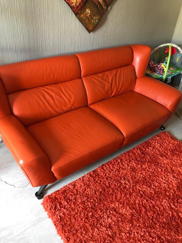 Orange Leather sofas and orange rug in Carrickfergus, County Antrim