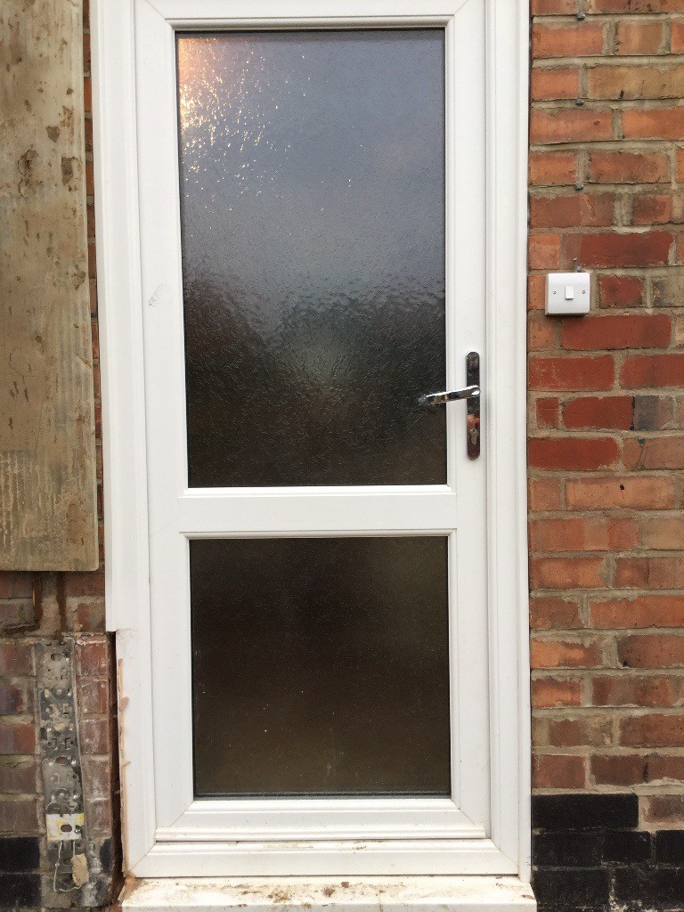 White UPvc double glazed back door and frame with opaque glass in