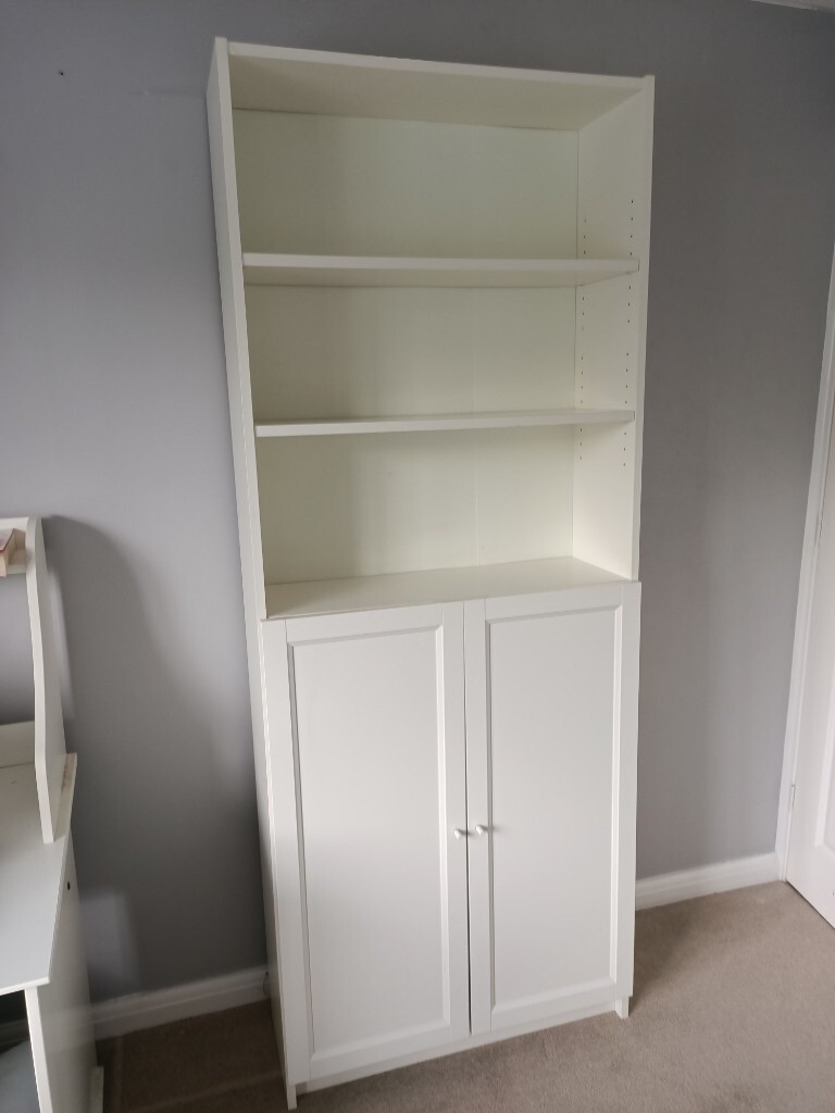 IKEA tall bookshelf / cupboard shelves with cupboard doors on the