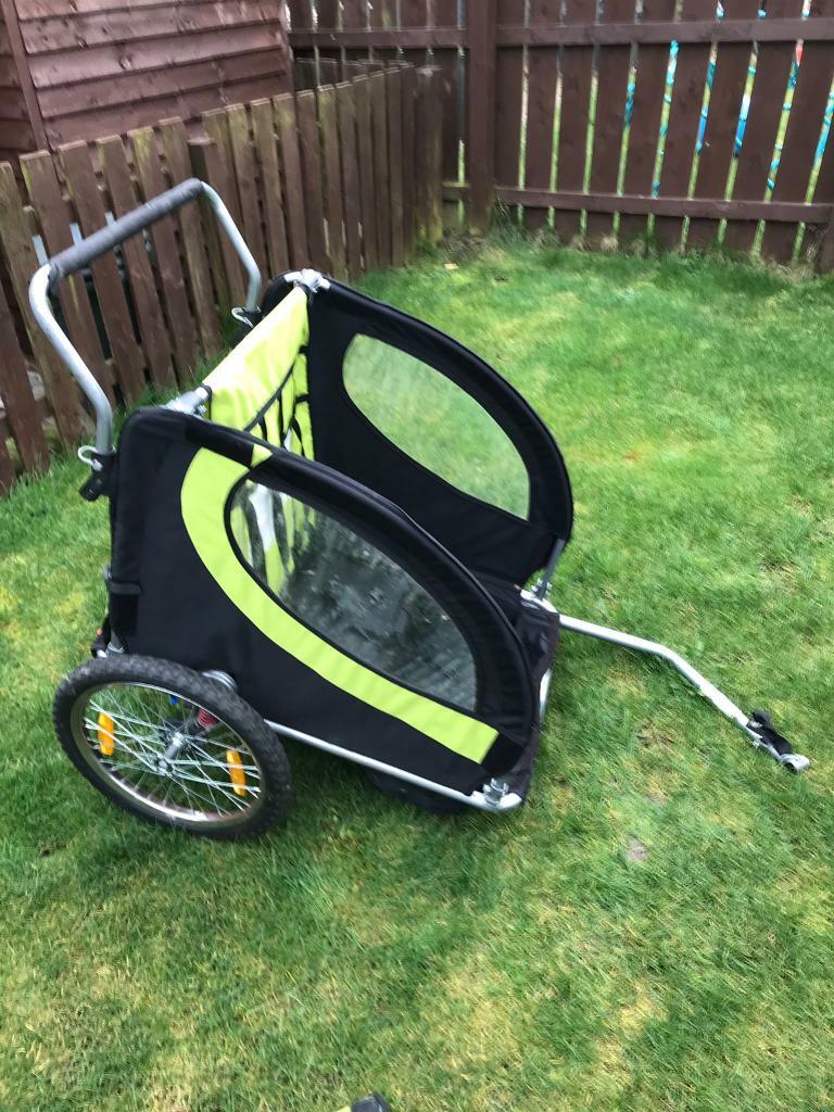 Child’s bike trailer for 2 children, used condition. Comes with rain