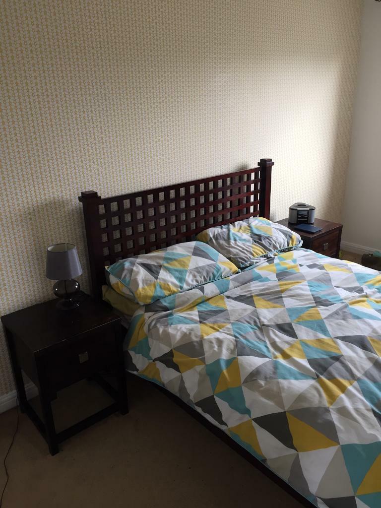 Double Bed Frame Beside Tables And Chest Of Drawers In Cardiff