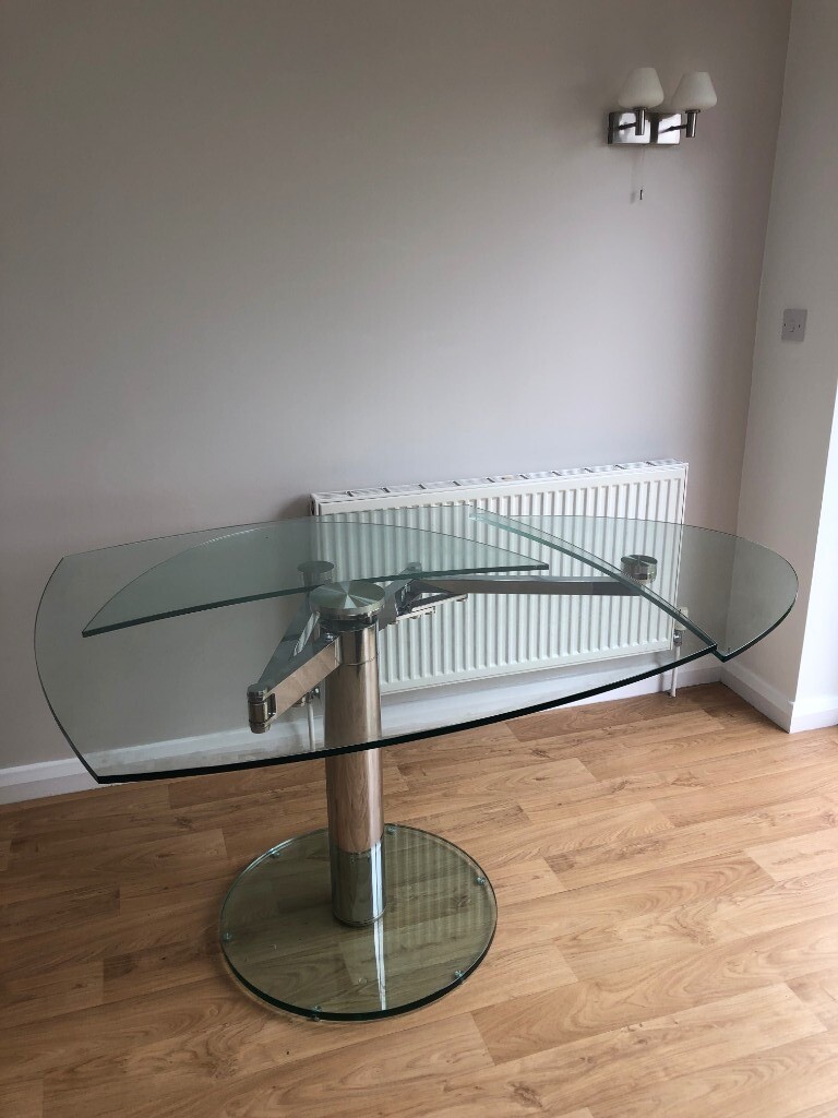 Dwell glass extending dining table with central pillar leg in