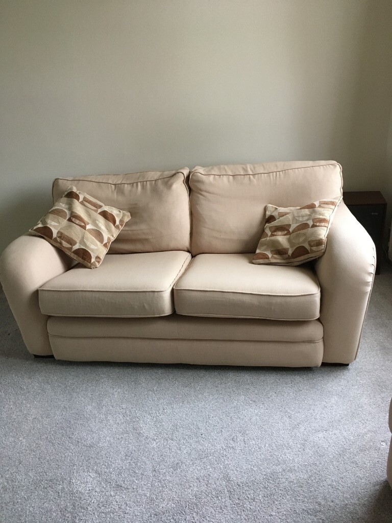 Cream fabric sofa and armchair with matching footstool in Brampton