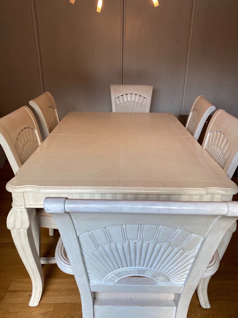 White wooden dining table, chairs, matching sideboard and console table