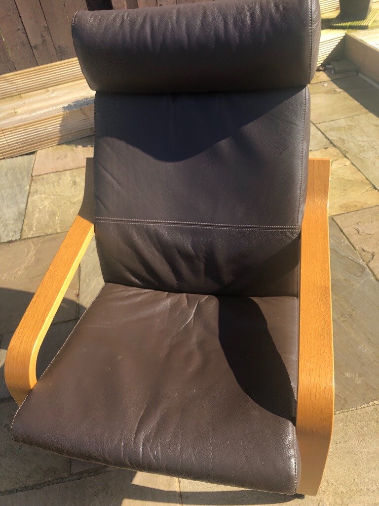 IKEA chairs with brown leather cushions and matching footstools in