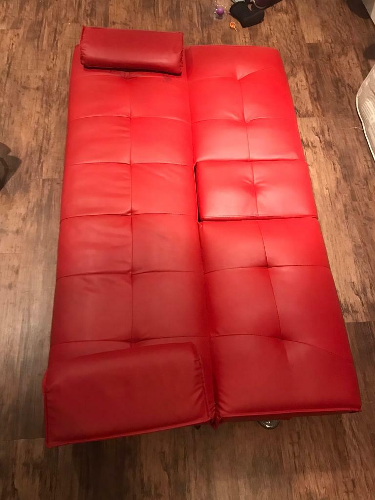 Stylish red faux leather Click Clack sofa bed in Peterborough