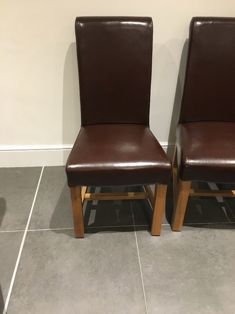 2 Brown Leather dining chairs with Solid Oak Legs in Eastleigh