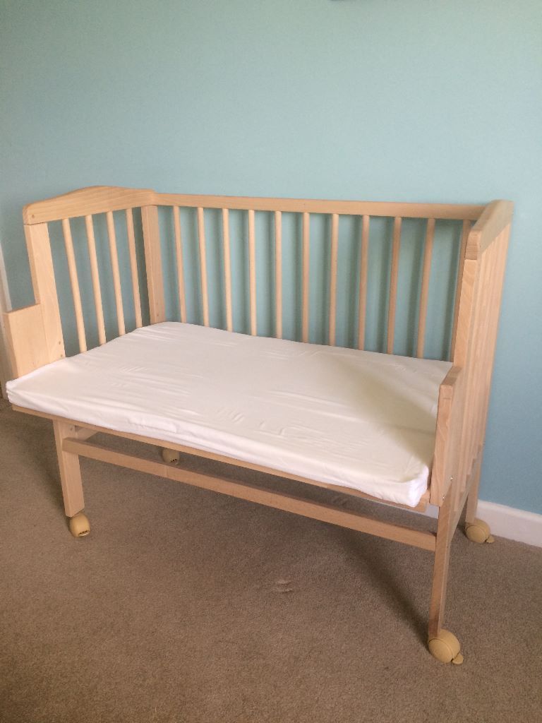 Asnew wooden bedside crib/cosleeper; heightadjustable with mattress
