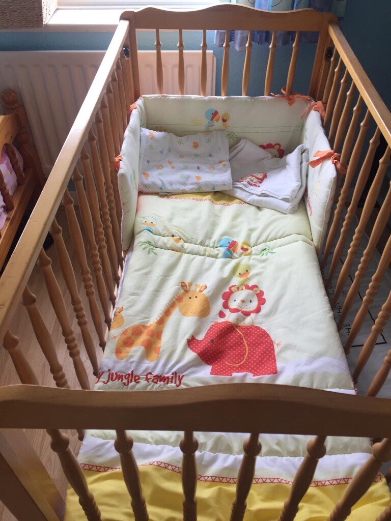 Light wood cot with adjustable sides. in Lytchett Matravers, Dorset