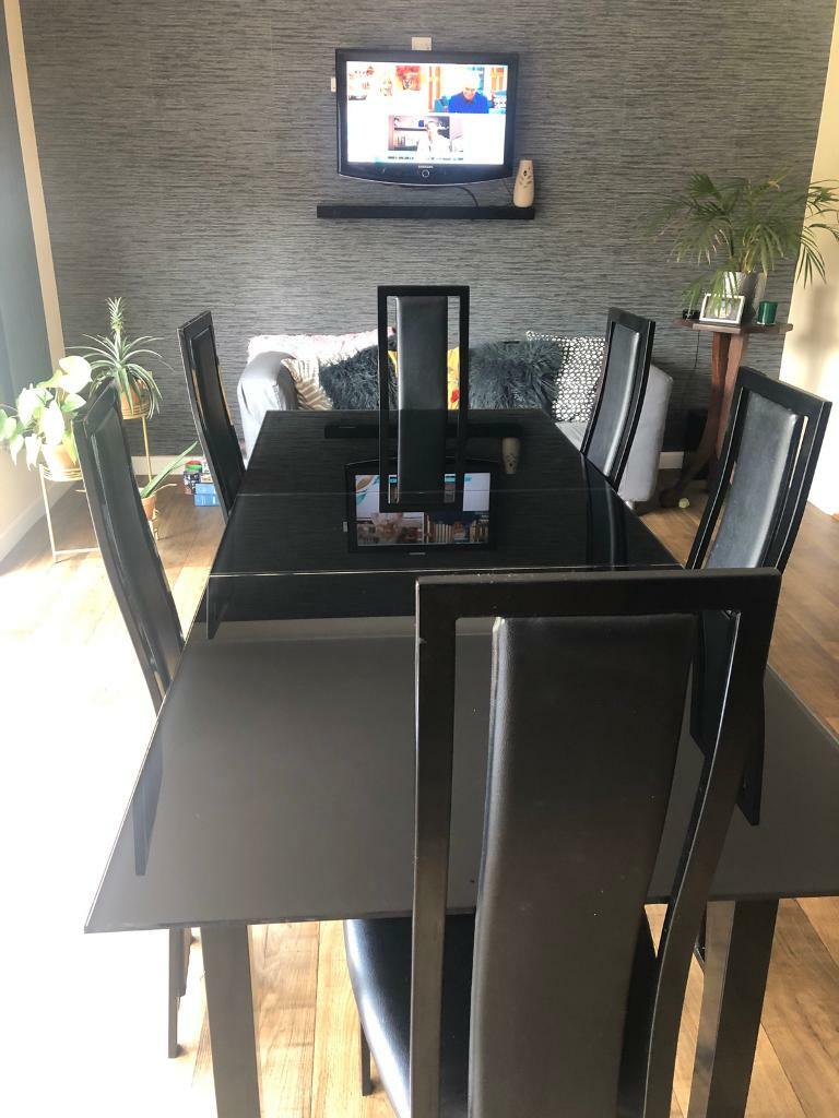 Extendable black glass dining table & 6 faux leather chairs in