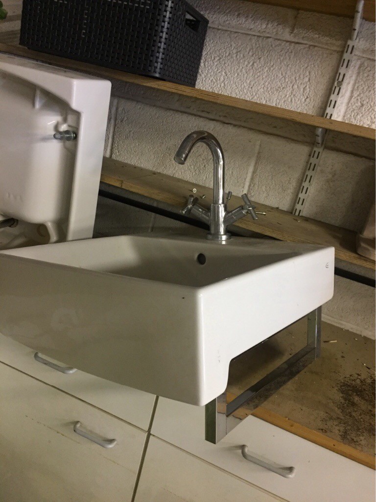 Two large bathroom sinks with taps part of double set