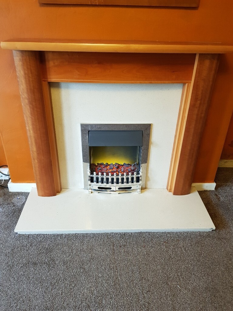Electric fire, marble hearth and back panel and wooden surround. in