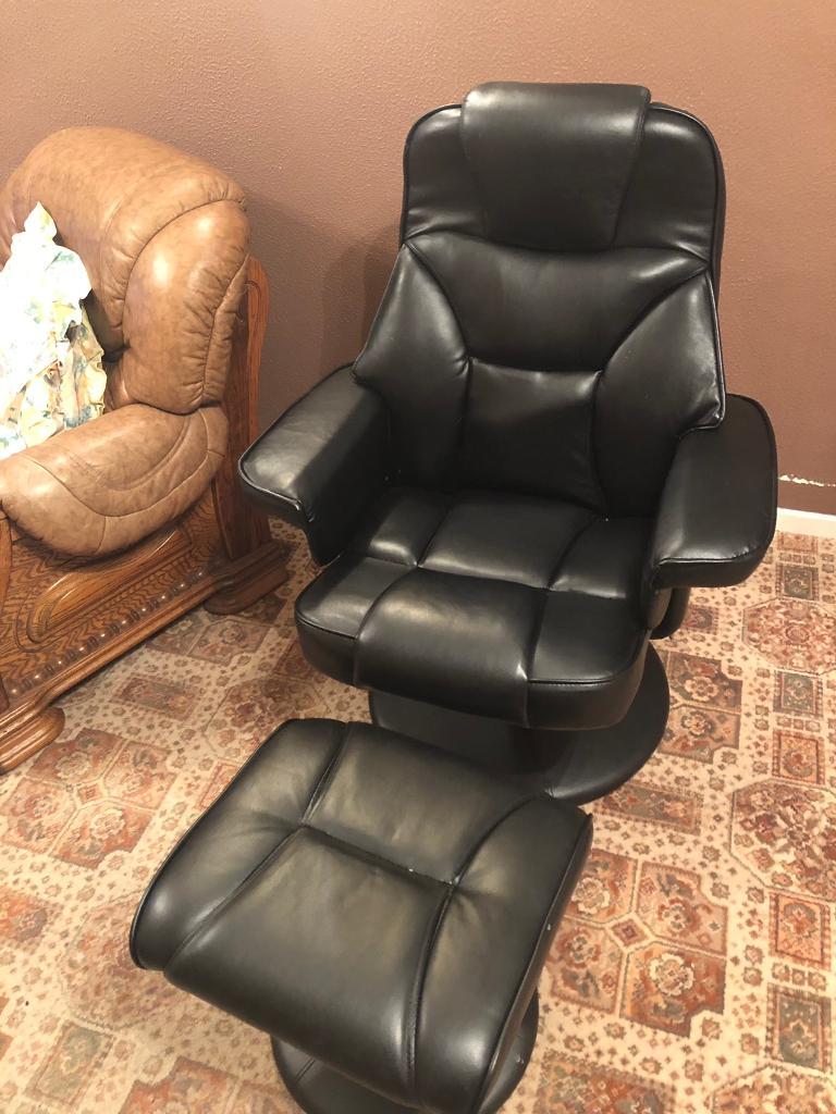 Black leather recliner chair with footstool in Castlerock, County