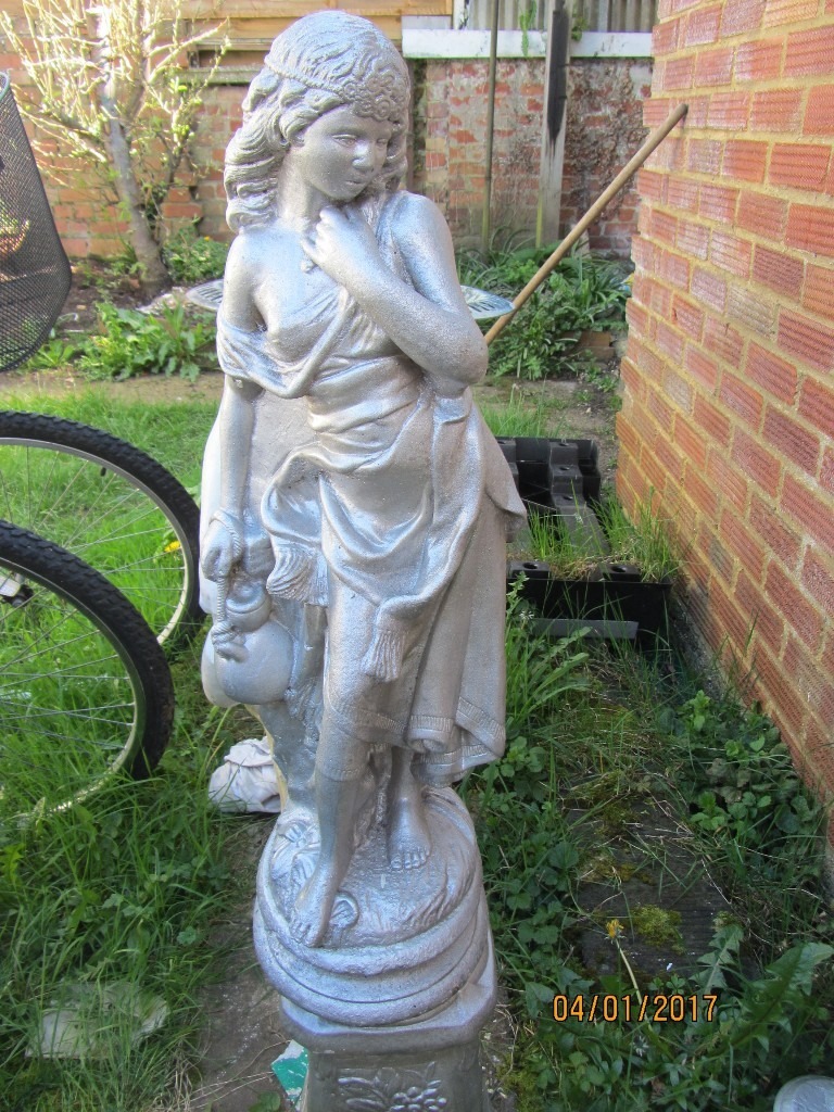 Garden statues of girls. Stone and on plinth. in Caversham, Berkshire