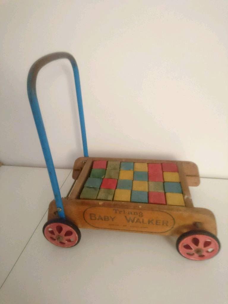 Vintage wooden toy blocks in Truck Triang trolley push along walker