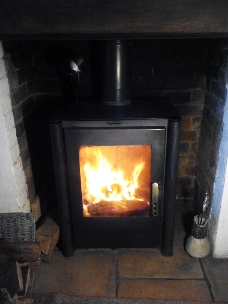 10KW multi fuel log burner in good used condition in black steel.Airwash system keeps glass