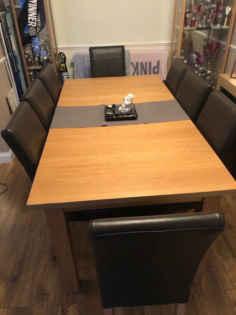 Solid extending dining room table that sits 8/10 no chairs just the