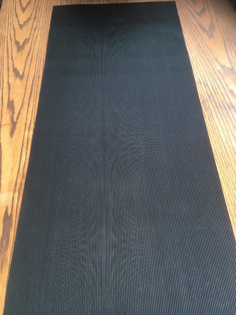 Black ribbed rubber matting measuring 965mm x 419mm x 3mm thick. in