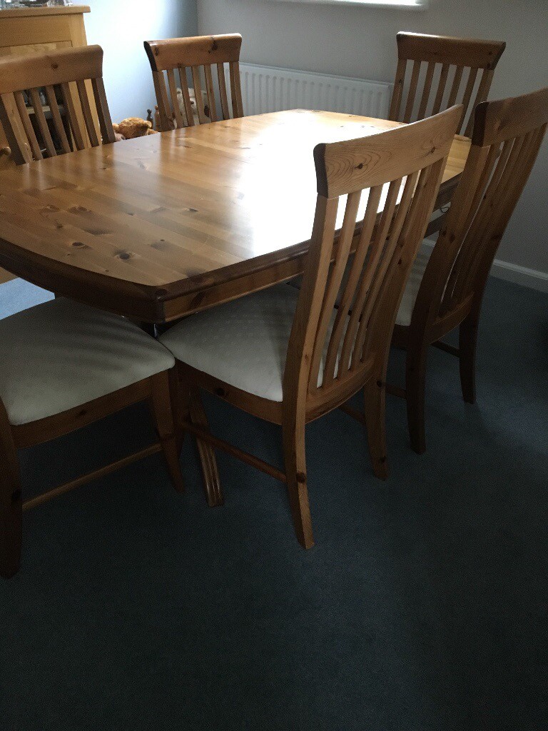 Light wood GPlan dining table and 6 chairs upholstered in cream. in