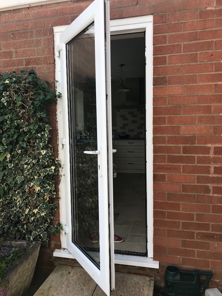 Nearly New Double Glazed White UPVC back door with frame and key in
