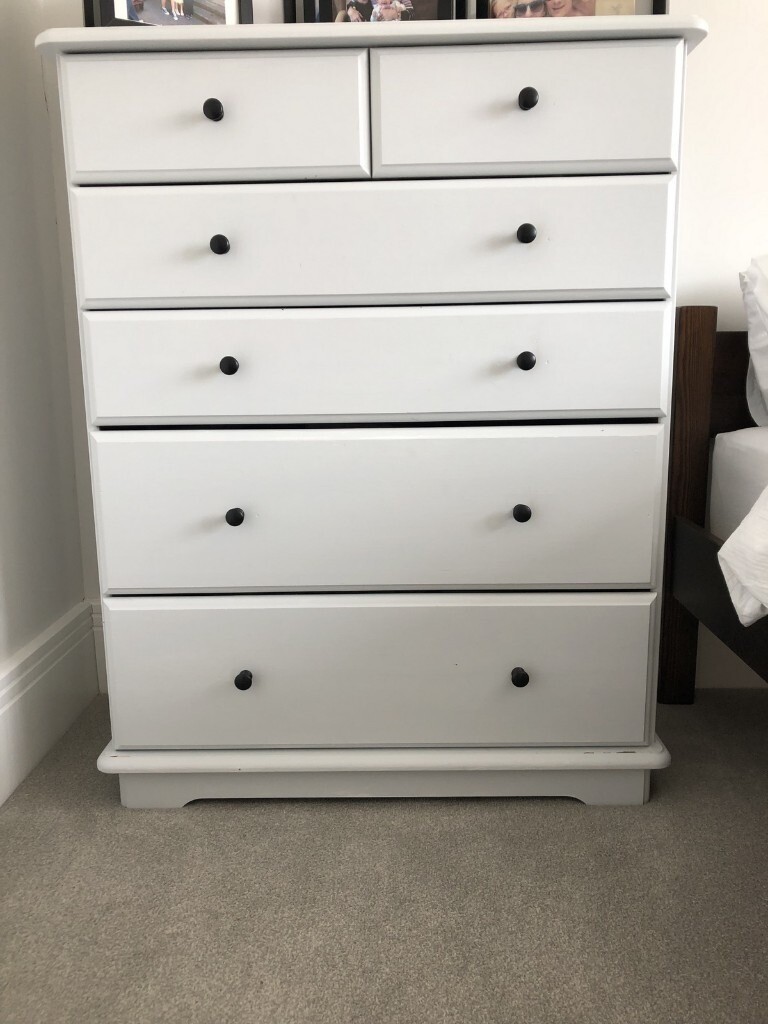 Light grey painted chest of drawers and matching bedside in