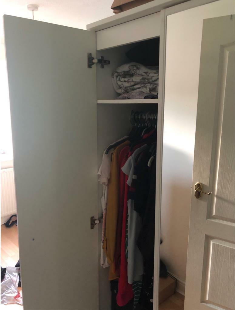 White Wardrobe With Mirror On One Side And Set Of White Drawers In