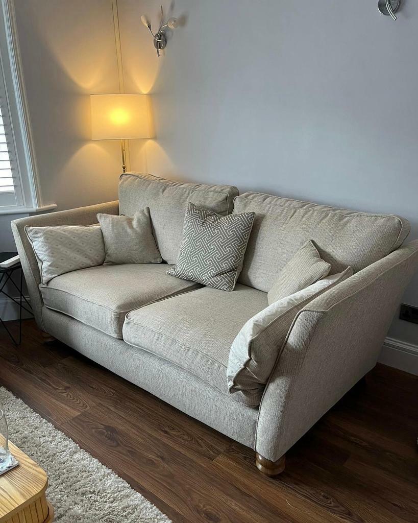 3 seater beige sofa with scatter cushions in Waltham