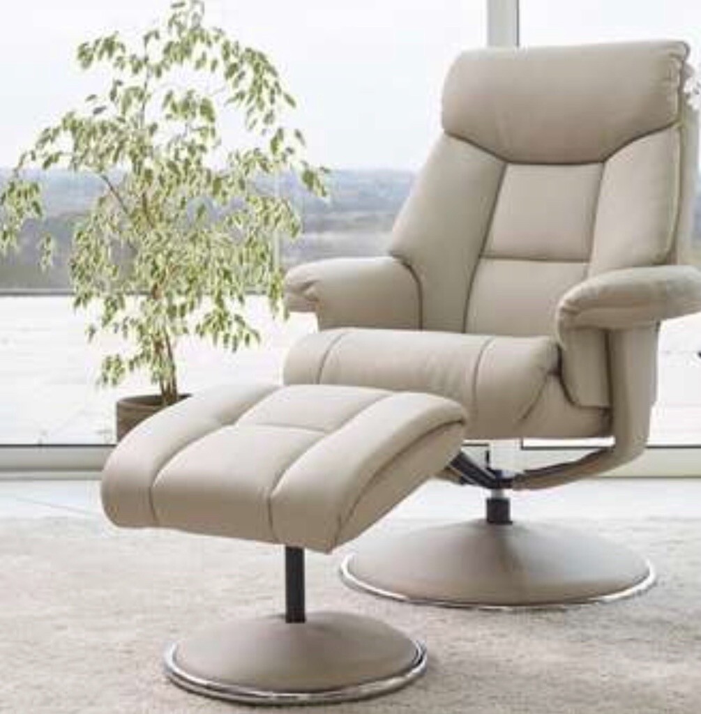 Two nearly new compact modern leather look swivel armchairs with