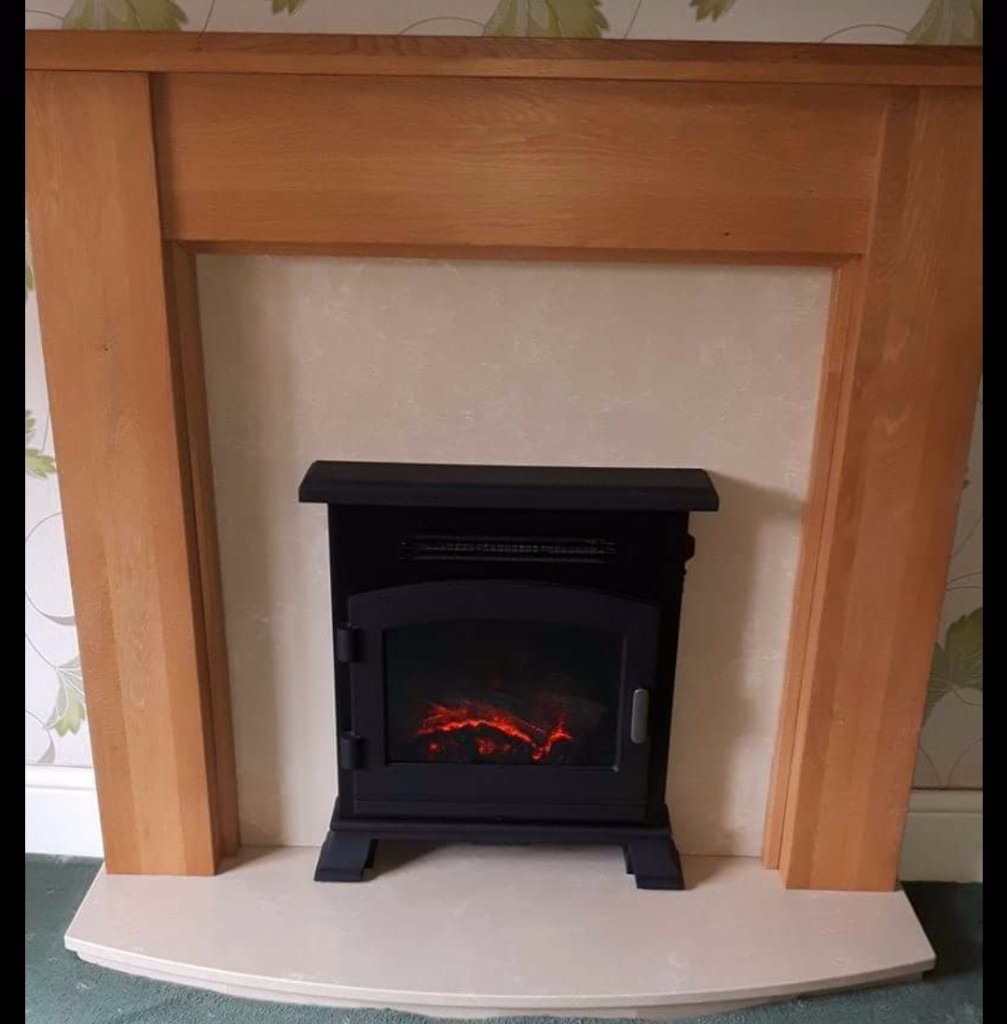 Solid Oak Fire Surround with back panel and Electric Stove. 49 ins wide