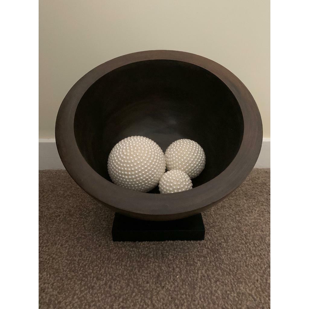 Beautiful large angled wooden bowl on black wooden base. Measures