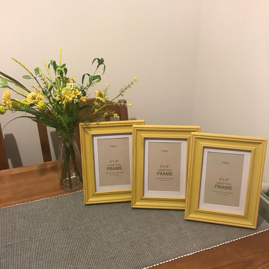 Next Home photo frames and vase of artificial flowers yellow homewear