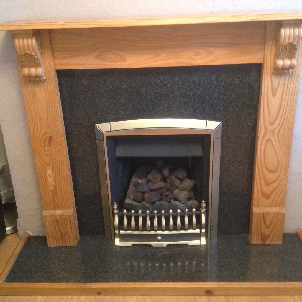 Coal effect gas fire and fireplace surround with hearth in Feltham