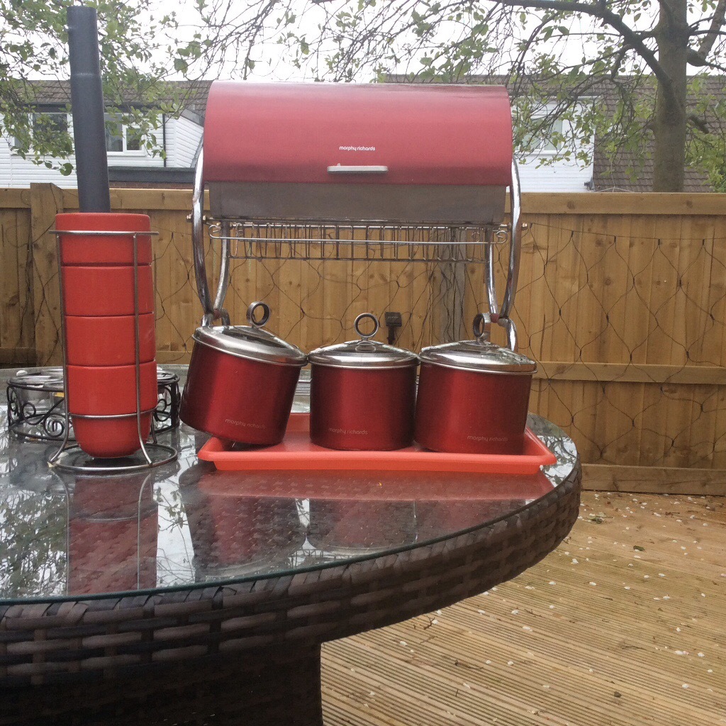 Red kitchen canisters, cups, plate drainer and breadbin ...