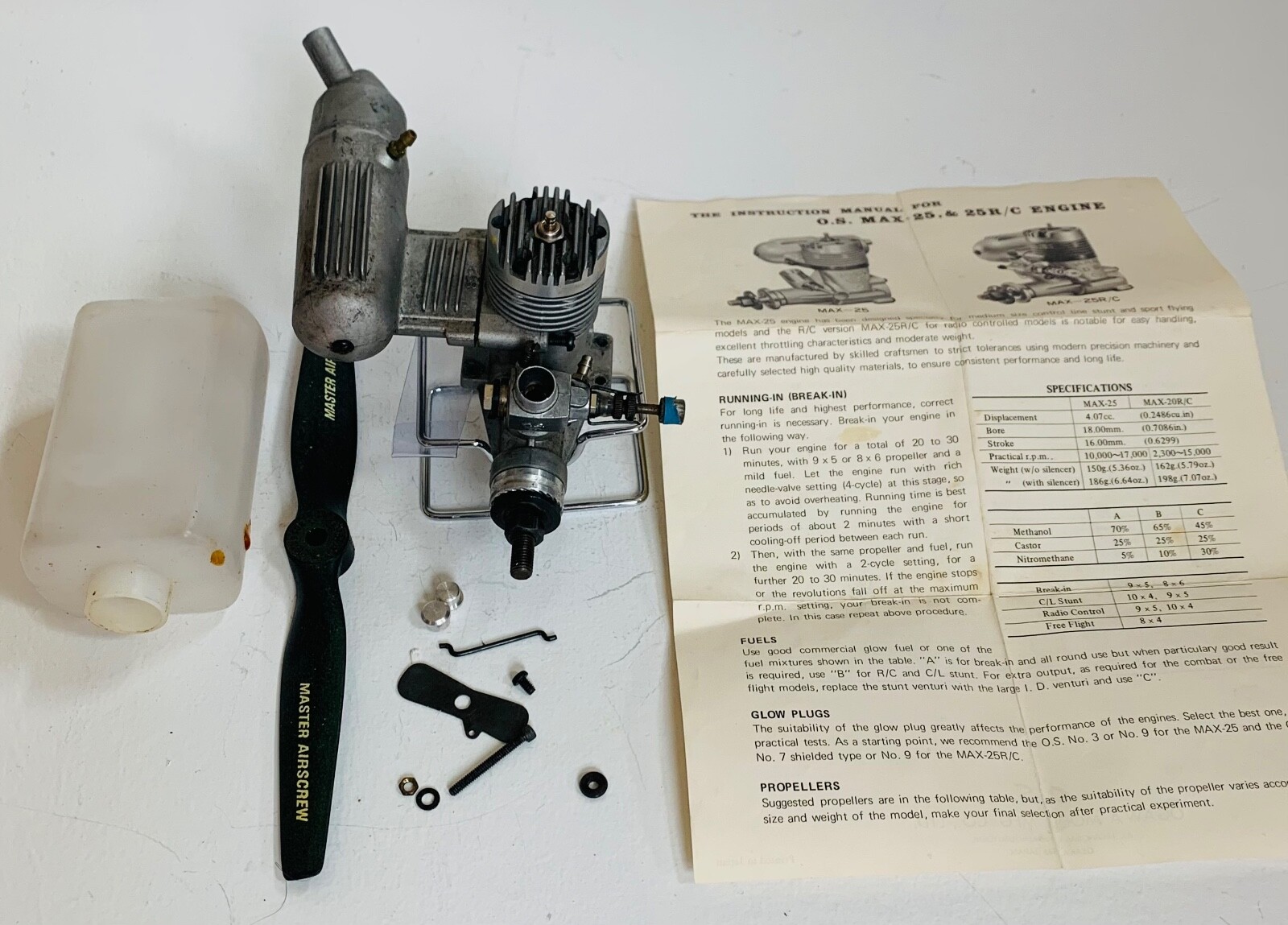 Collectible O.S. Max SF .25 model engine with muffler, prop