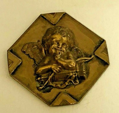 1 cupid button in painted enamels 1 and a half inch by 2 inch.