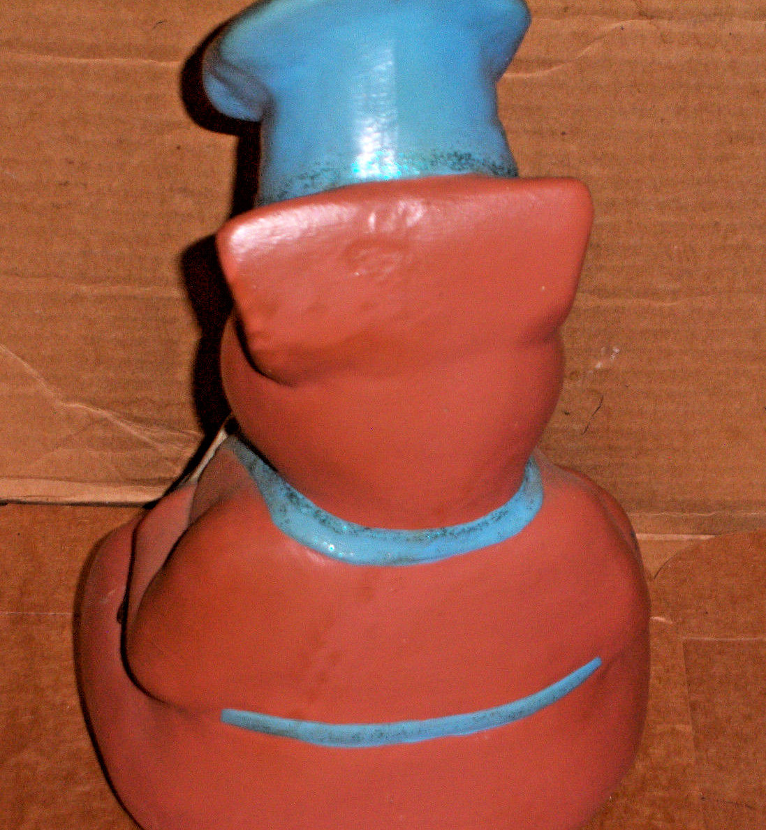 Pig holding a silver fork and wearing a blue apron marked CHEF