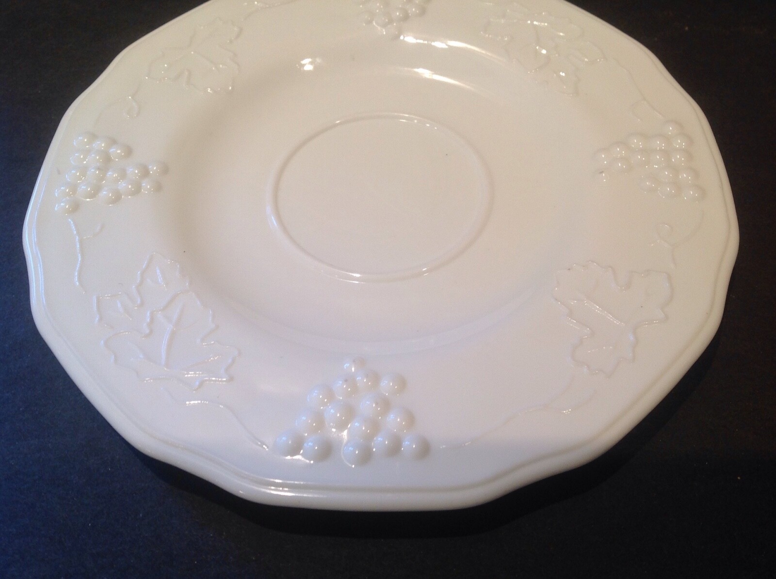 Two vintage milk glass saucers grape design.