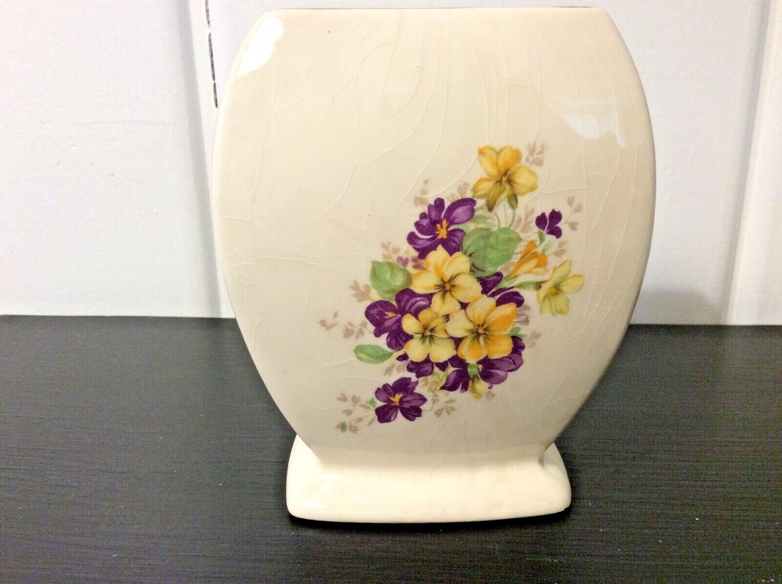 Small vintage cream colored vase with yellow and purple pansies