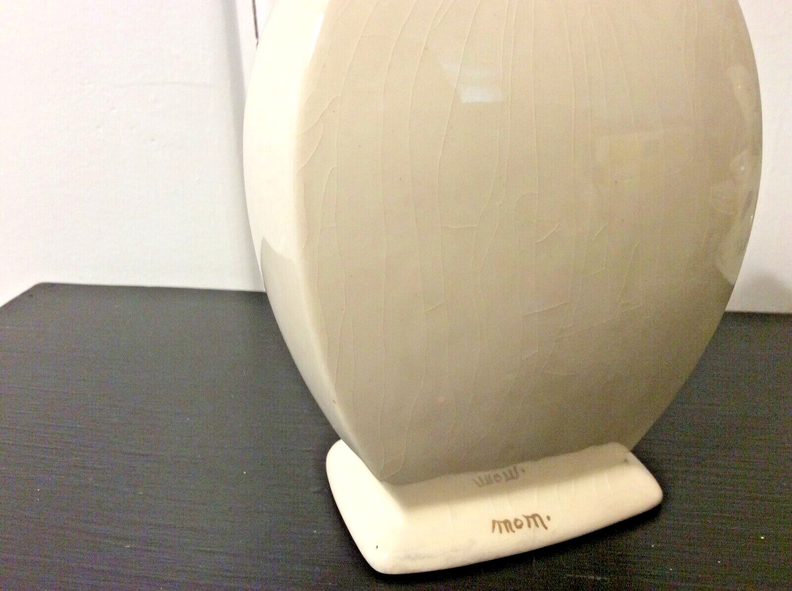 Small vintage cream colored vase with yellow and purple pansies