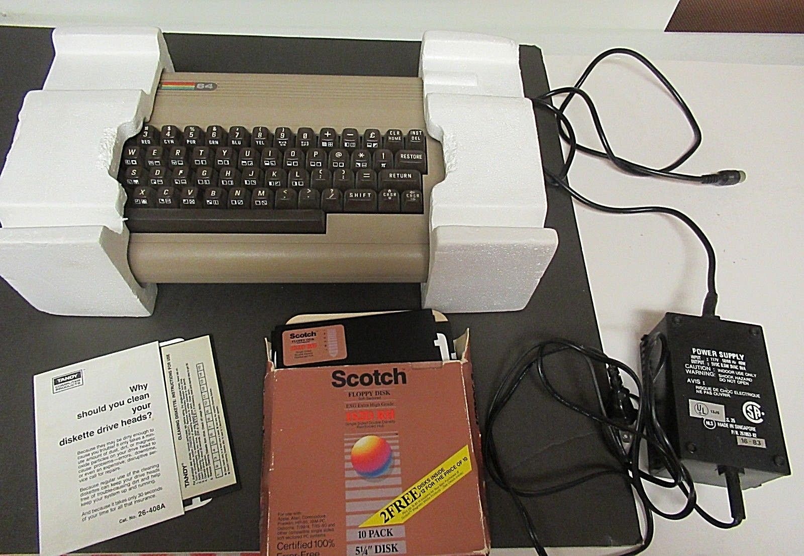 COMMODORE 64 WITH ORIGINAL BOX, POWER CORD, 11 FLOPPY DISKS, DISK DRIVE CLEANER