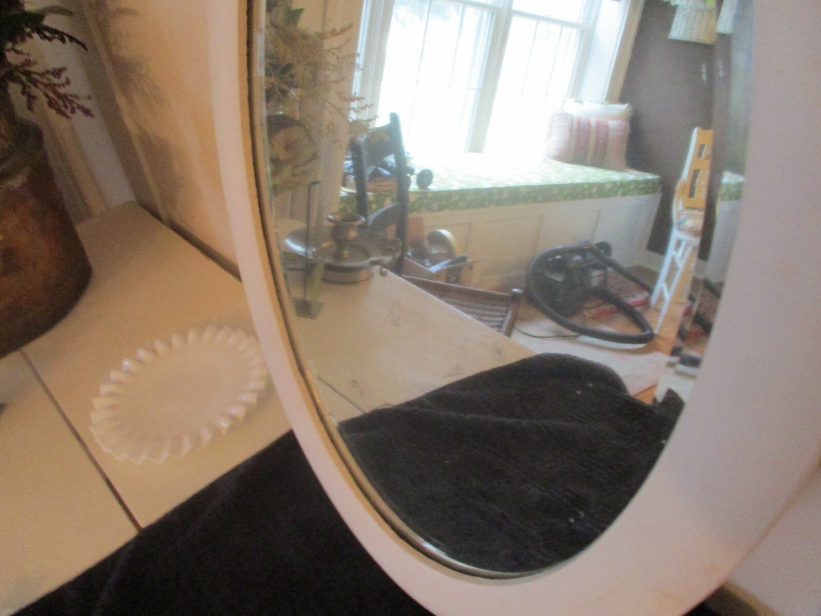 Antique beveled oval mirror. Creamy white.