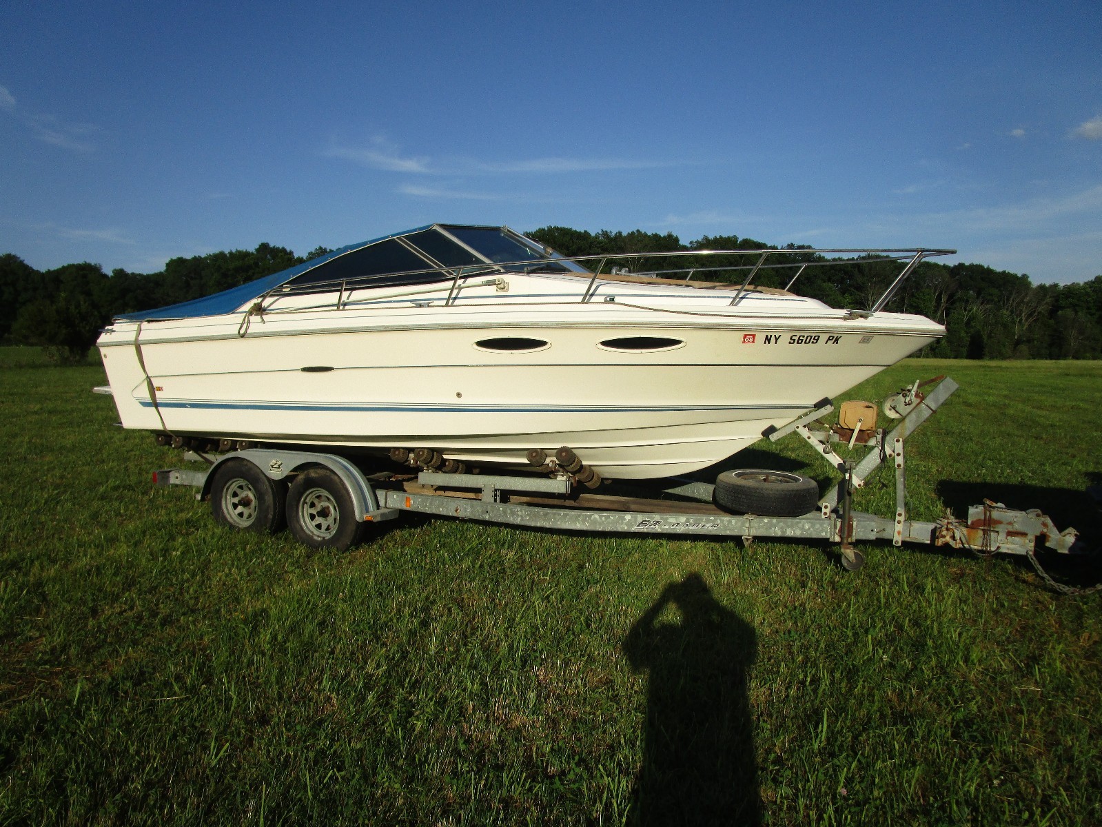 1986 Sea Ray 23 ft sport cuddy on EZLoader trailer 230 mercruiser 426 hrs.