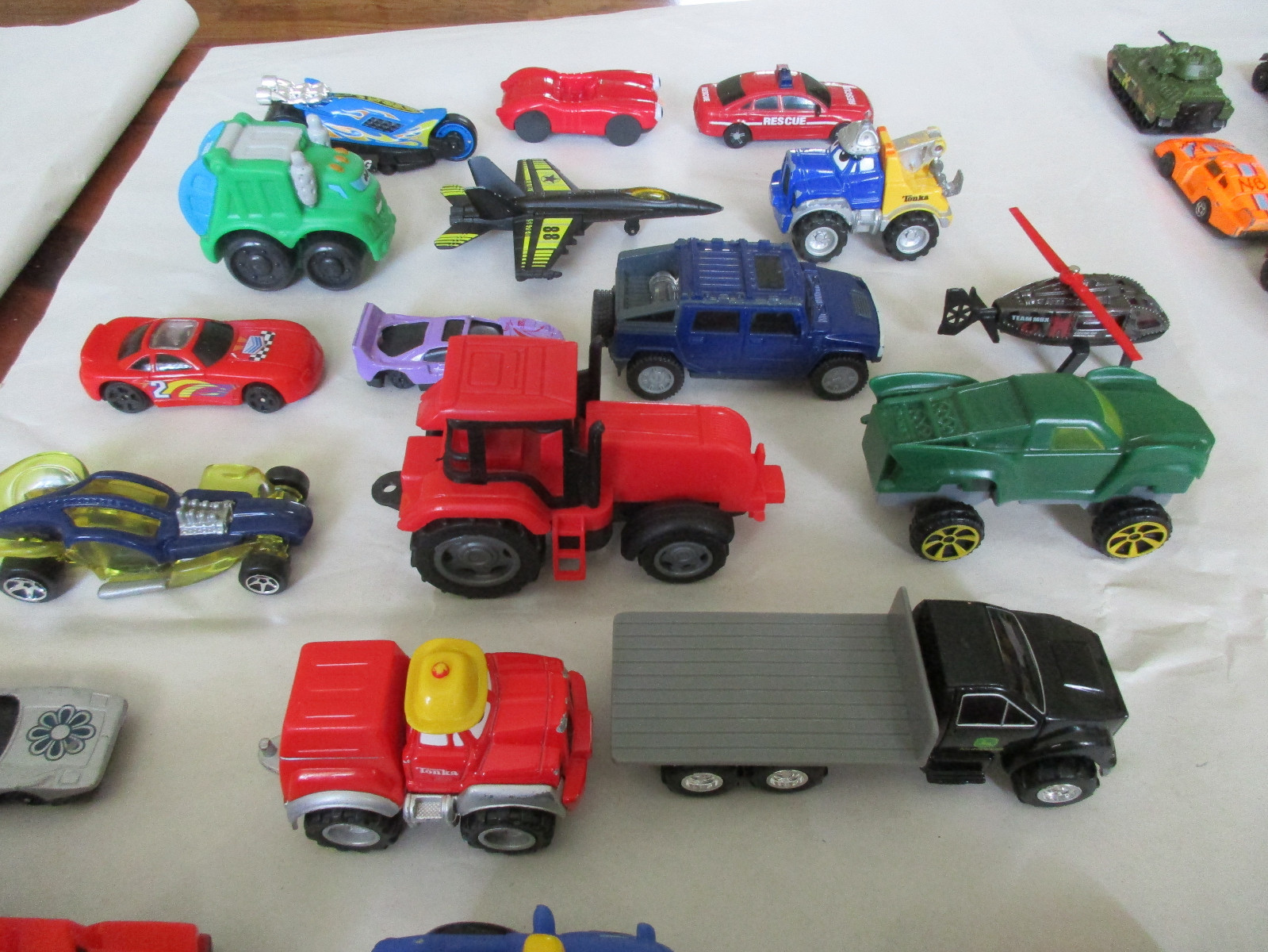 Lot of 59 of Toy Cars, Trucks, a Helicopter, a Plane, a Tank and a Tractor.