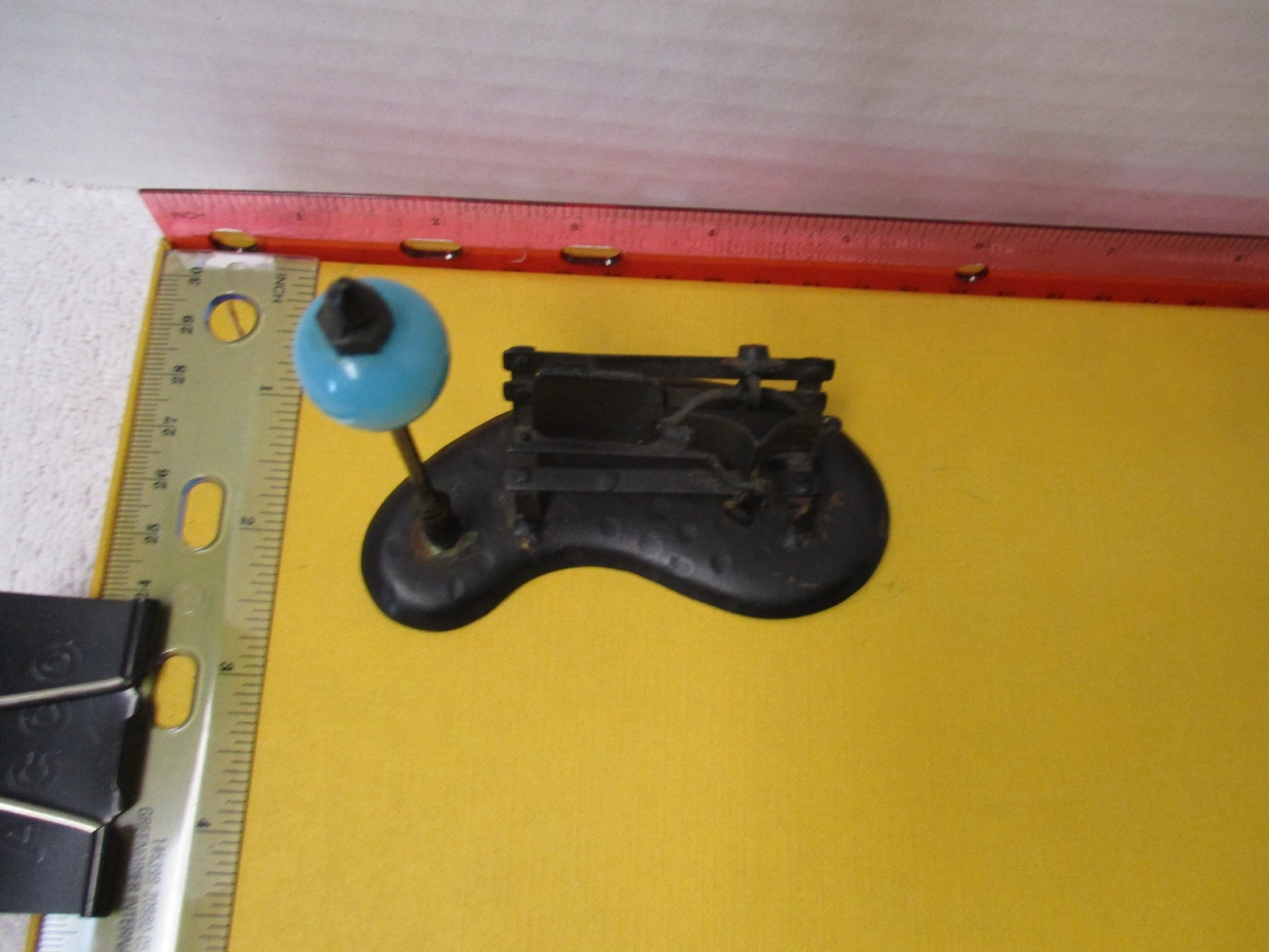 Metal Sculpture Of Man on Bench near Light Pole 