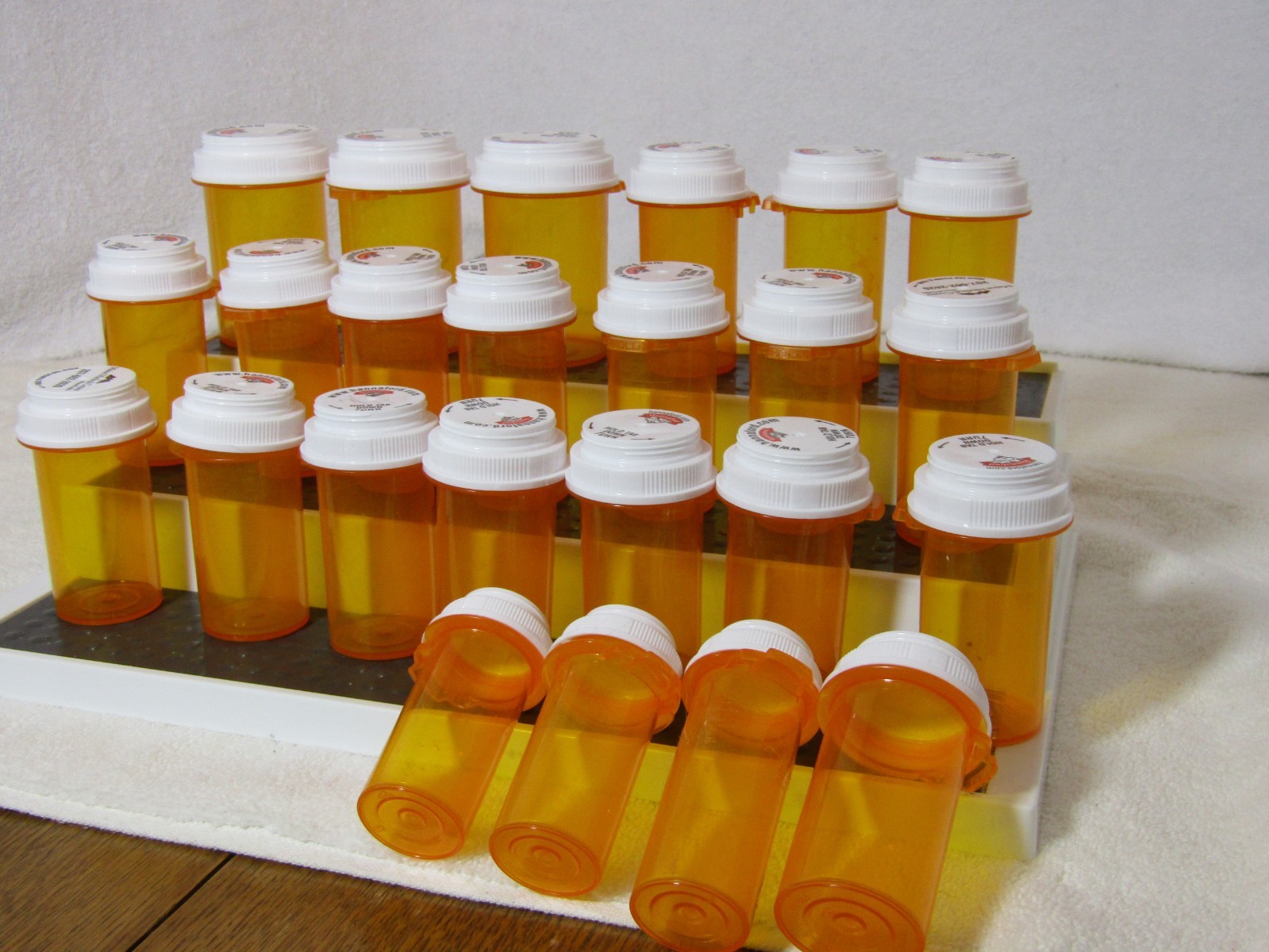 used 24 empty amber pill bottles, assorted sizes, clean, good for storage