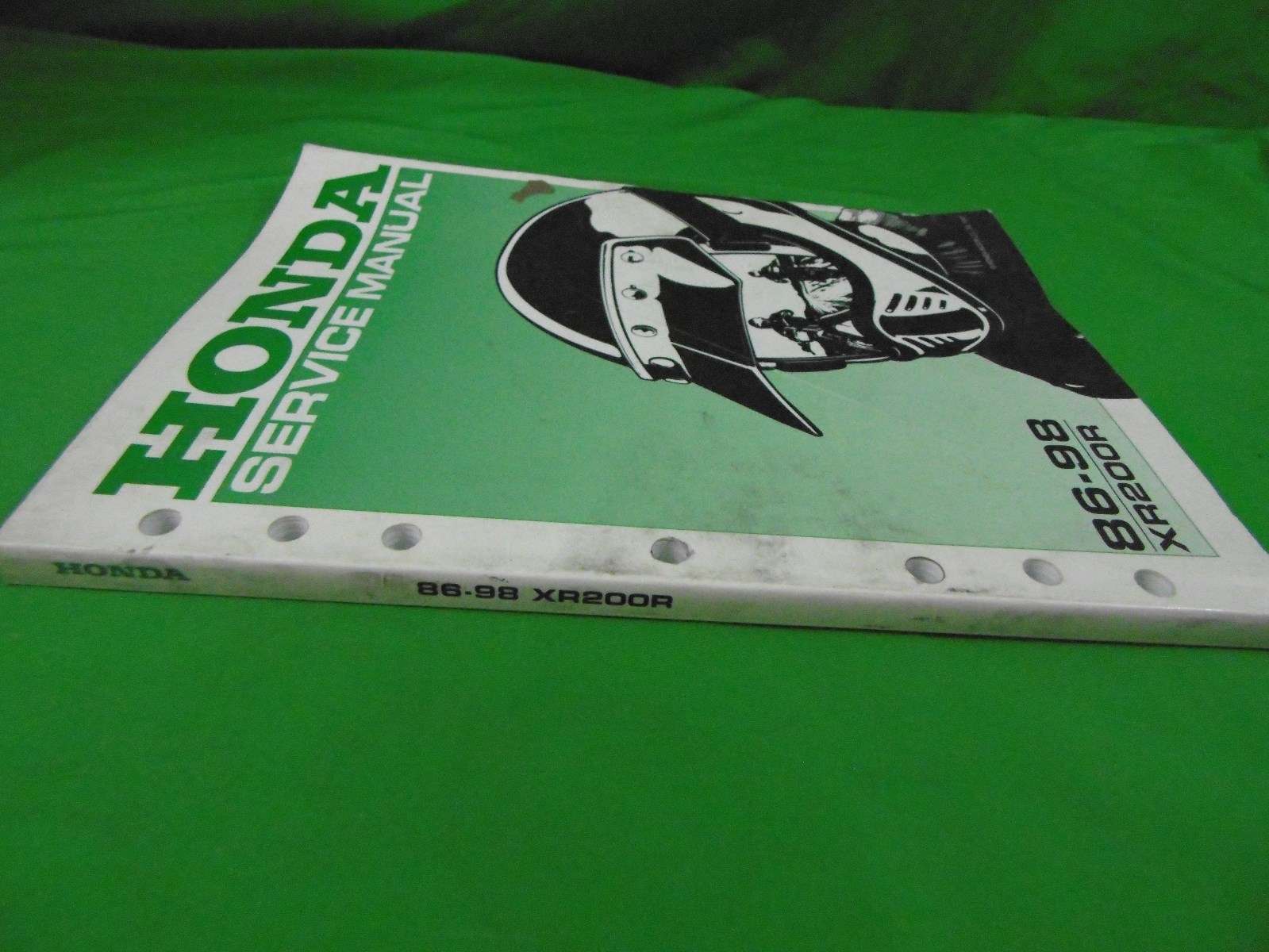 This Listing is for a Used Genuine Honda 1986 - 1998 XR200R Service Manual  - Used condition - Front Cover has some damage along edge, See Pictures ...