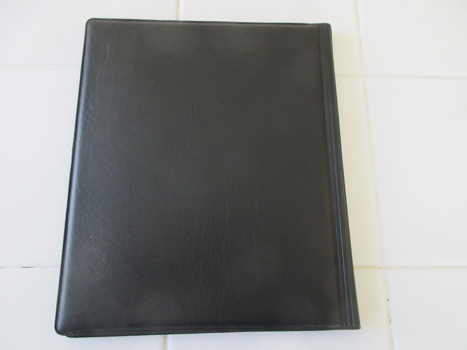 Address Book enclosed in Black Vinyl Folder.  9”x7.5”