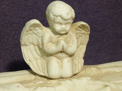 Hanging ceramic dish with cherubs, 8 1/2