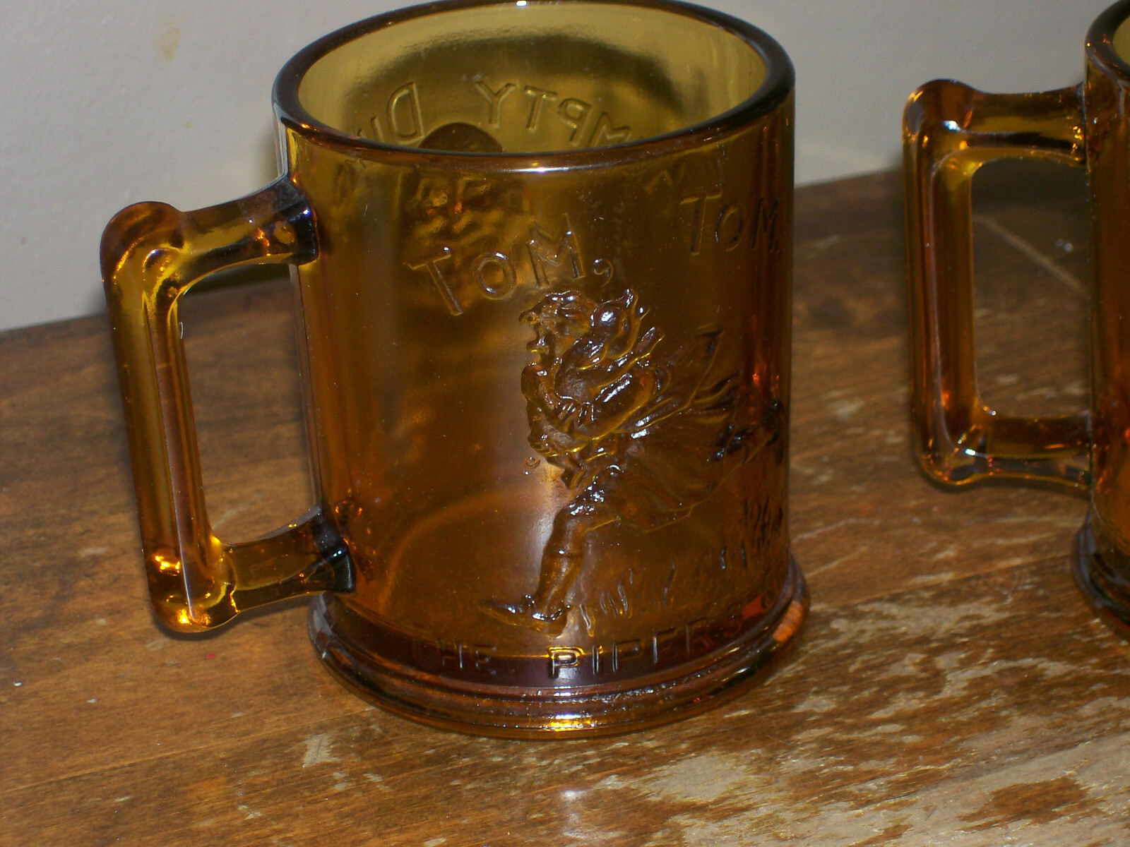 2 Amber Glass Mugs Childs Nursery Rhyme Humpty Dumpty Tom Tom Handle Vintage